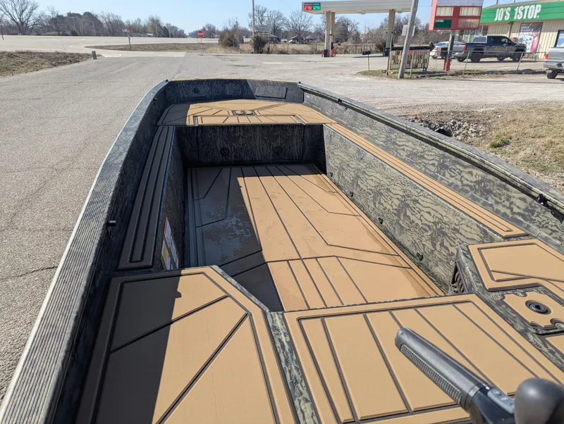 Slide: The Image of 2025 Tracker Grizzly 1650 T Prairie Wings Edition boat parked outdoors. - 13