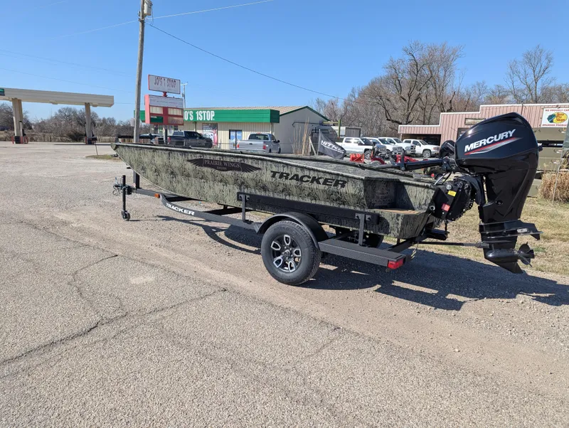 Slide: The Image of 2025 Tracker Grizzly 1650 T Prairie Wings Edition boat with Mercury engine on trailer. - 2