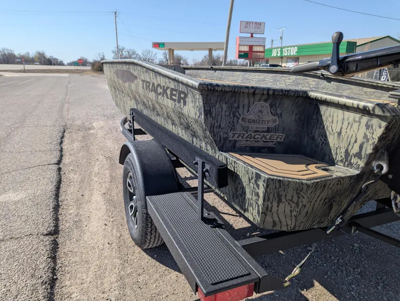 Slide: The Image of 2025 Tracker Grizzly 1650 T Prairie Wings Edition boat on trailer, camo design. - 3