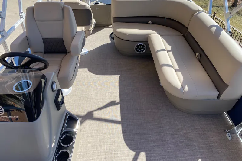 Slide: The Image of 2025 Sun Tracker Bass Buggy 18 DLX interior with beige seating and steering console. - 4