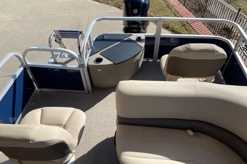 Slide: The Image of 2025 Sun Tracker Bass Buggy 18 DLX pontoon boat interior with seating and motor. - 5