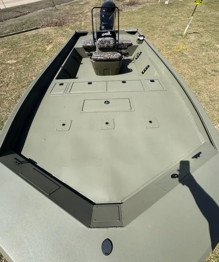 Slide: The Image of 2025 Tracker Grizzly 2072 CC boat, spacious deck, camo seats, outdoor setting. - 5