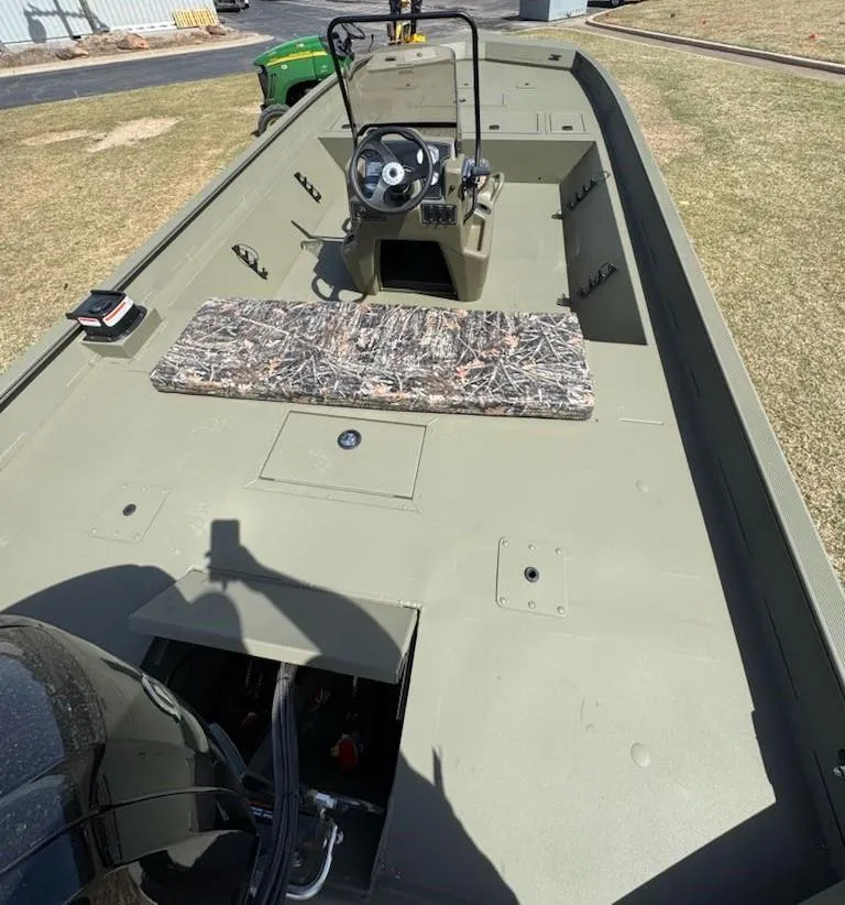 Slide: The Image of 2025 Tracker Grizzly 2072 CC boat with camouflage seat, steering console, and spacious deck. - 6