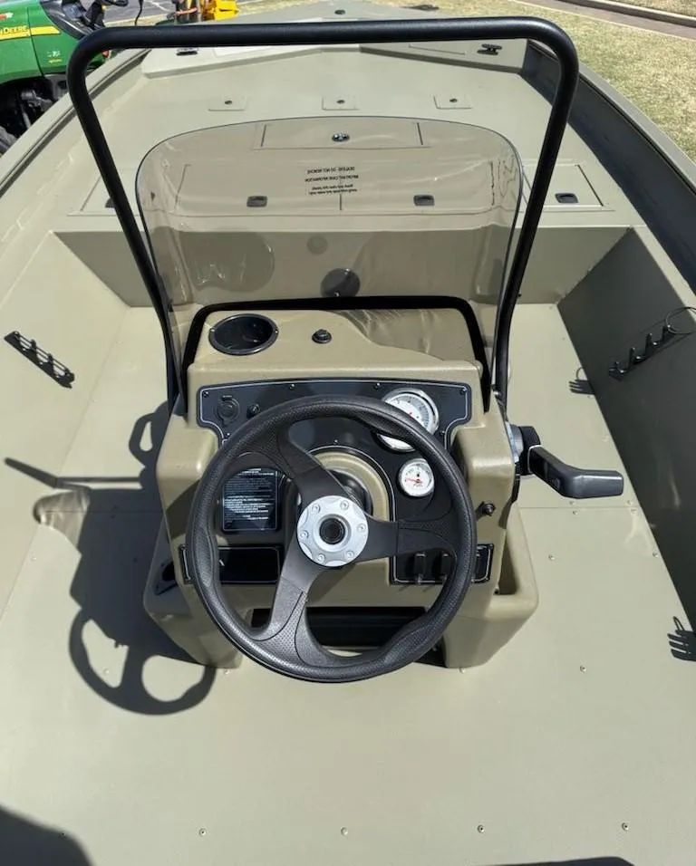 Slide: The Image of 2025 Tracker Grizzly 2072 CC boat console with steering wheel and gauges. - 8