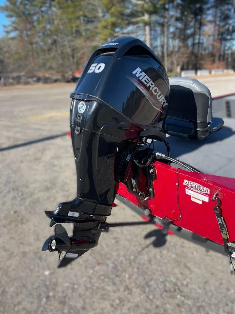 Slide: The Image of 2025 Tracker Bass Tracker Classic XL with Mercury 50 outboard motor, parked outdoors. - 4