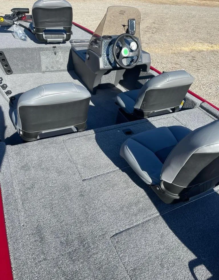 Slide: The Image of 2025 Tracker Bass Tracker Classic XL interior with gray seating and steering console. - 5