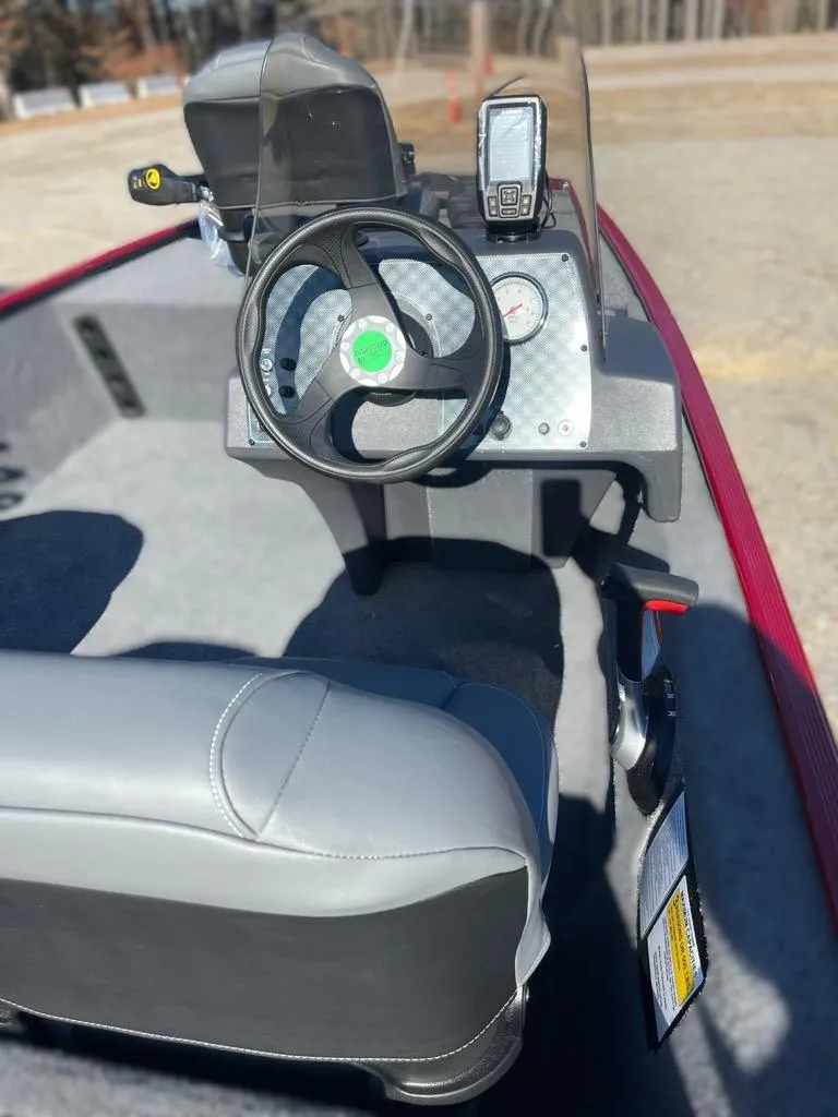 Slide: The Image of 2025 Tracker Bass Tracker Classic XL boat interior with steering wheel and dashboard controls. - 6