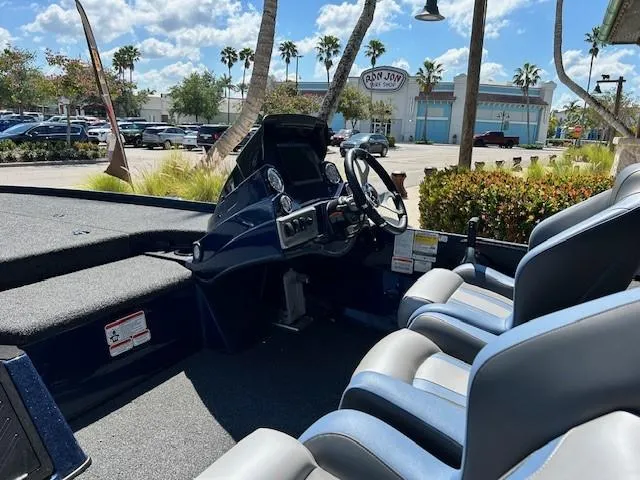 Slide: The Image of 2025 Nitro Z18 Pro boat interior with steering wheel and seating, parked outdoors. - 5