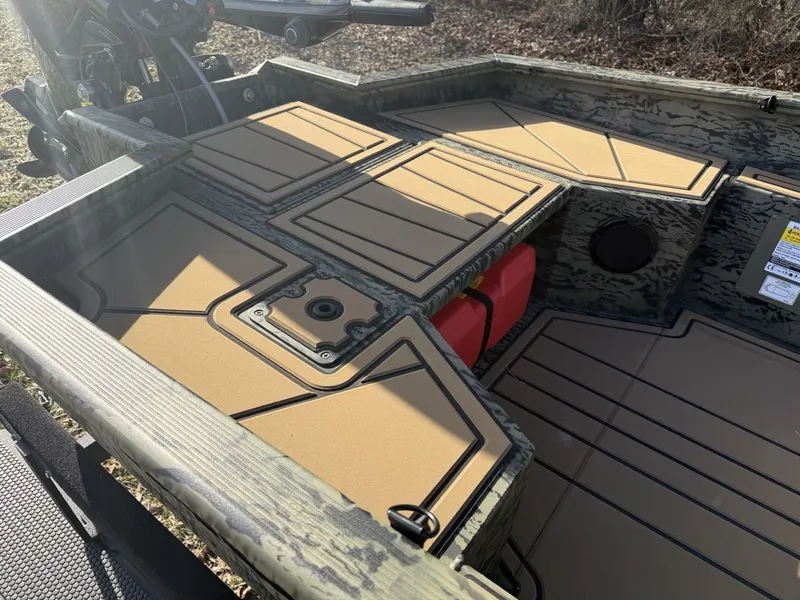 Slide: The Image of 2025 Tracker Grizzly 1650 T Prairie Wings Edition boat interior with storage compartments. - 5