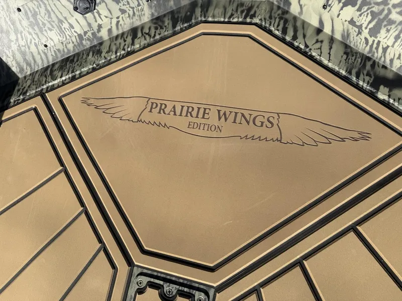 Slide: The Image of 2025 Tracker Grizzly 1650 T Prairie Wings Edition boat deck with logo. - 7