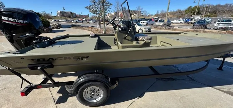 Slide: The Image of 2025 Tracker Grizzly 1860 CC boat on trailer, featuring Mercury outboard motor. - 2