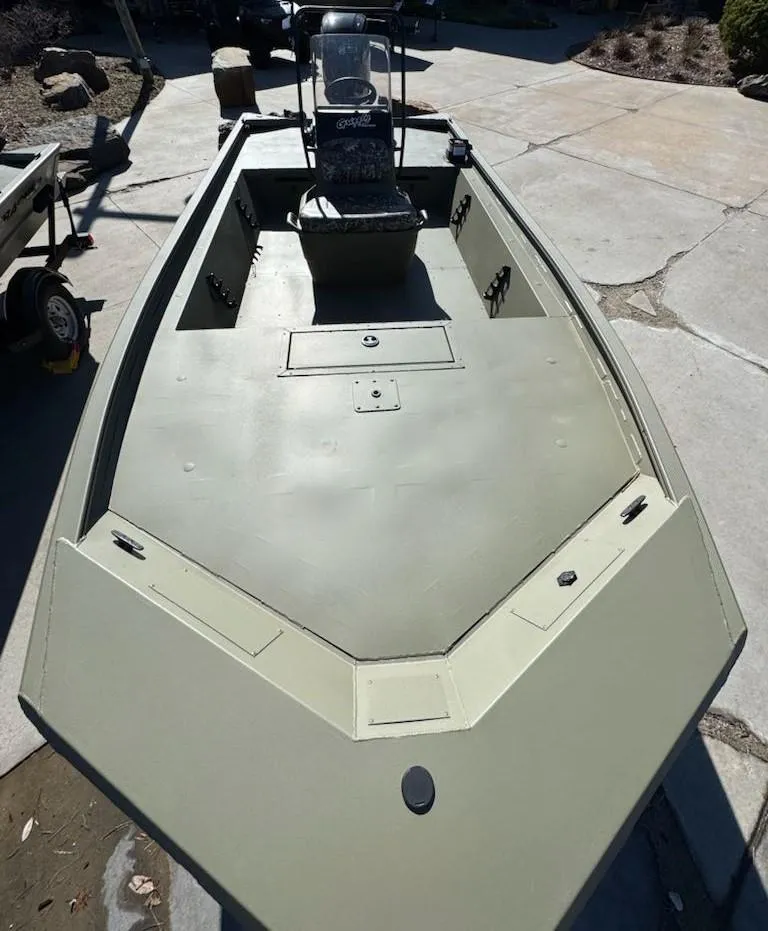 Slide: The Image of 2025 Tracker Grizzly 1860 CC boat, spacious deck, center console, outdoor setting. - 6