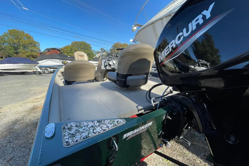 Slide: The Image of 2025 Tracker Bass Tracker Classic Limited boat with Mercury engine, parked outdoors. - 43