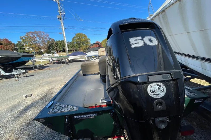 Slide: The Image of 2025 Tracker Bass Tracker Classic Limited boat with Mercury 50 engine, parked outdoors. - 44