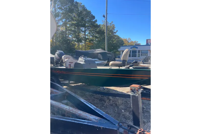 Slide: The Image of 2025 Tracker Bass Tracker Classic Limited boat on trailer, parked outdoors. - 45