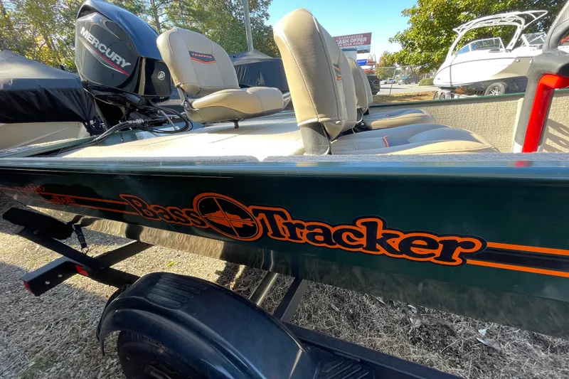 Slide: The Image of 2025 Tracker Bass Tracker Classic Limited boat with Mercury engine, parked outdoors. - 47