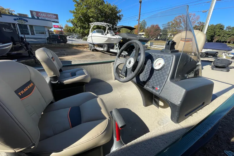 Slide: The Image of 2025 Tracker Bass Tracker Classic Limited boat interior with steering wheel and seats. - 48