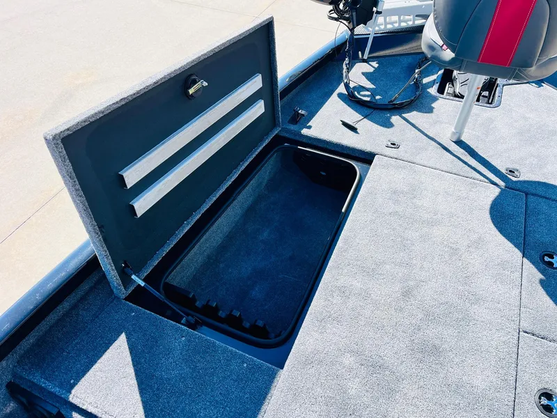 Slide: The Image of 2024 Ranger RT198P boat storage compartment with open lid and seating area. - 15