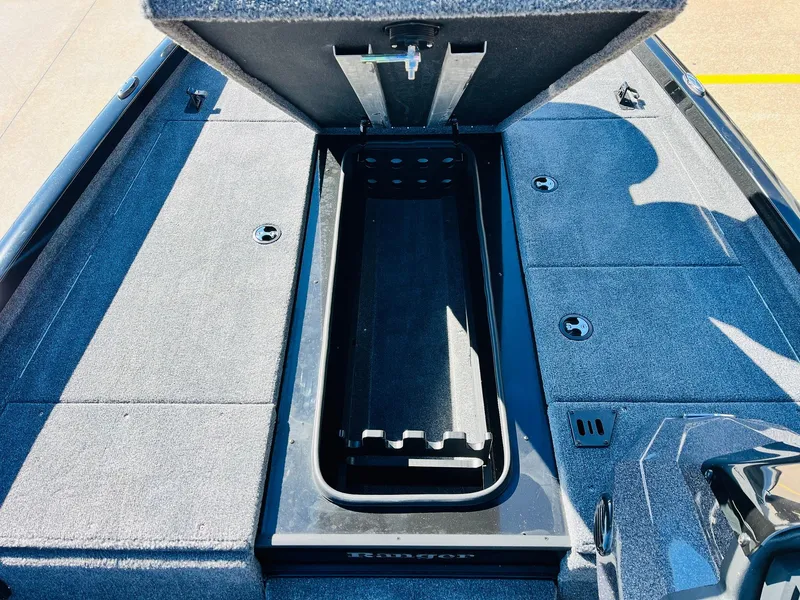Slide: The Image of 2024 Ranger RT198P boat storage compartment with open lid, showcasing spacious interior. - 17
