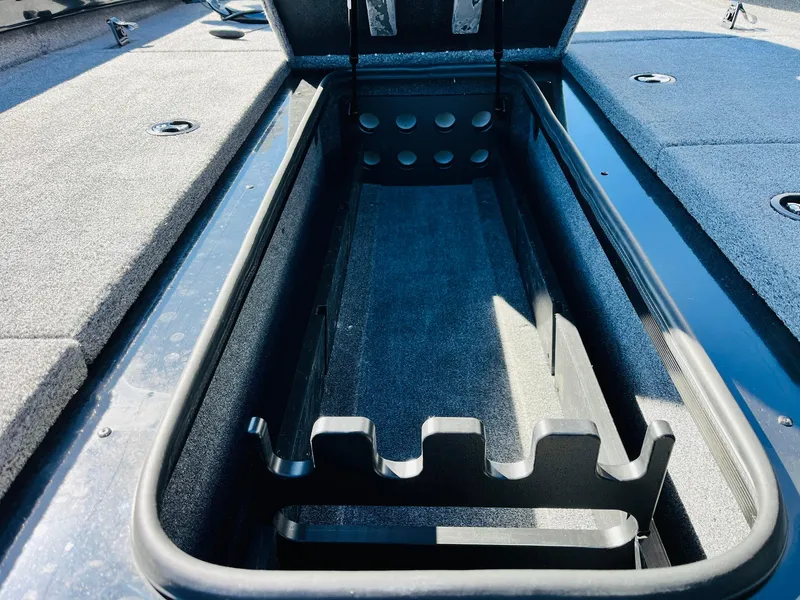 Slide: The Image of 2024 Ranger RT198P boat storage compartment with rod holders, open and empty. - 18
