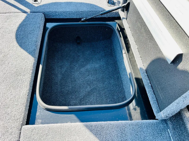 Slide: The Image of 2024 Ranger RT198P boat storage compartment with open lid, showcasing interior space. - 20