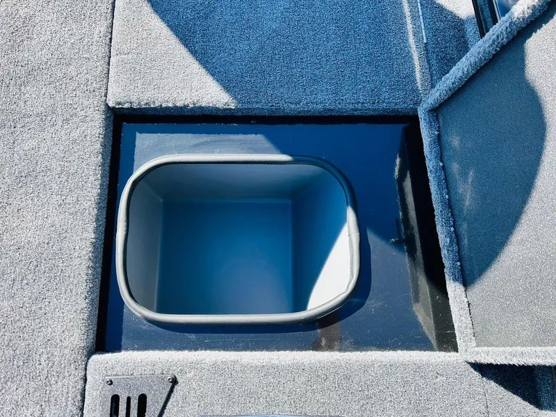 Slide: The Image of 2024 Ranger RT198P boat storage compartment with open lid, showcasing interior space. - 22