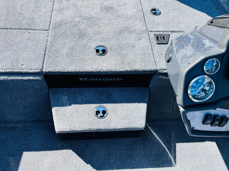 Slide: The Image of 2024 Ranger RT198P boat interior with carpeted steps and dashboard gauges. - 23