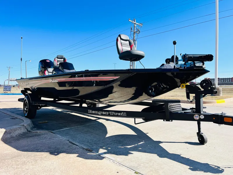 Slide: The Image of 2024 Ranger RT198P fishing boat on trailer, sleek black design, outdoor setting. - 3