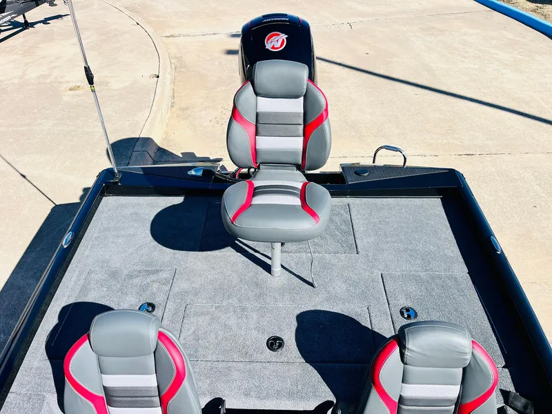 Slide: The Image of 2024 Ranger RT198P boat interior with three gray and red seats on a carpeted deck. - 31