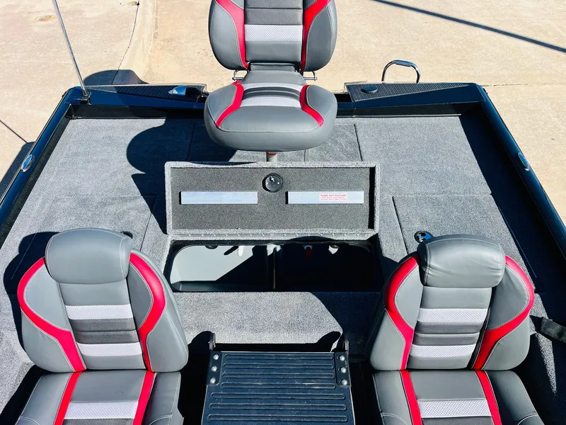 Slide: The Image of 2024 Ranger RT198P boat interior with gray and red seats, spacious deck, and storage compartments. - 32