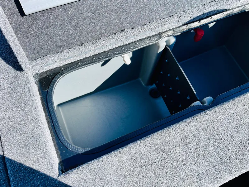 Slide: The Image of 2024 Ranger RT198P boat storage compartment, open and empty, with textured surface. - 34