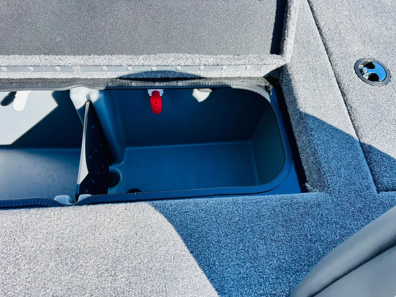 Slide: The Image of 2024 Ranger RT198P boat storage compartment with open lid, showcasing interior details. - 35
