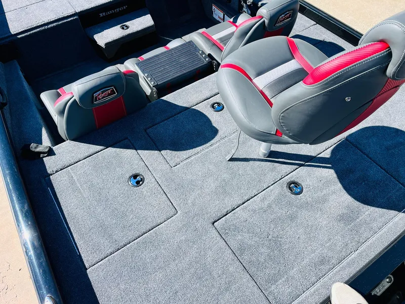 Slide: The Image of 2024 Ranger RT198P boat interior with gray and red seating and storage compartments. - 36