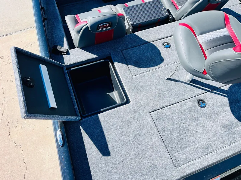 Slide: The Image of 2024 Ranger RT198P boat interior with open storage compartment and cushioned seats. - 37