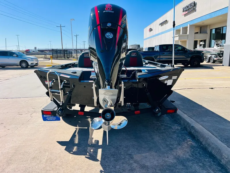 Slide: The Image of 2024 Ranger RT198P boat with powerful outboard motor in a dealership parking lot. - 6