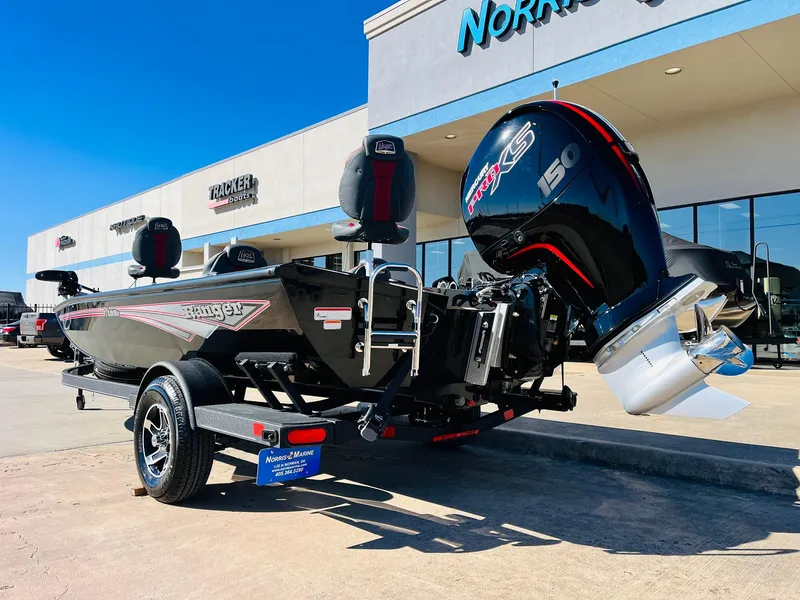 Slide: The Image of 2024 Ranger RT198P boat with powerful outboard motor, parked outside dealership. - 7