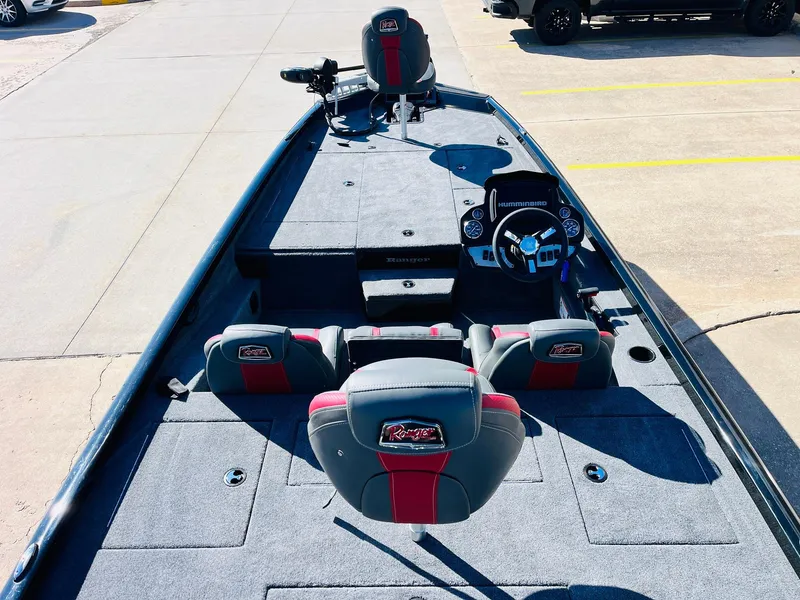 Slide: The Image of 2024 Ranger RT198P boat interior with gray and red seating, steering console, and spacious deck. - 9