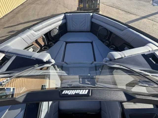 Slide: The Image of 2025 Malibu 25 LSV boat interior with luxurious seating and modern design. - 12