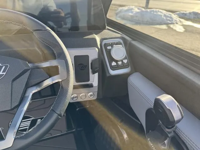 Slide: The Image of 2025 Malibu 25 LSV boat dashboard with steering wheel and control panel. - 18