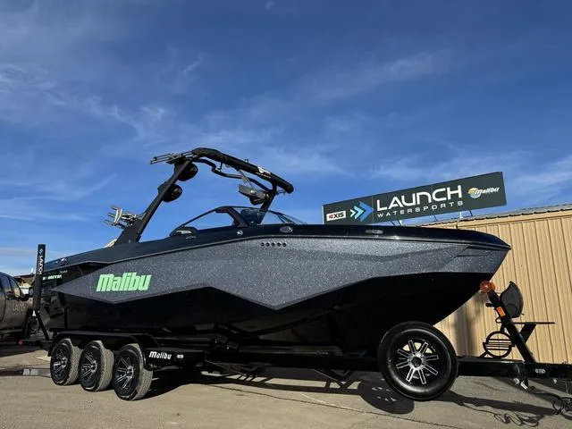 Slide: The Image of 2025 Malibu 25 LSV boat on trailer at Launch Watersports dealership. - 3
