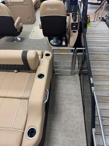 Slide: The Image of 2025 Barletta Lusso L25UC boat interior with beige seating and cup holders. - 14