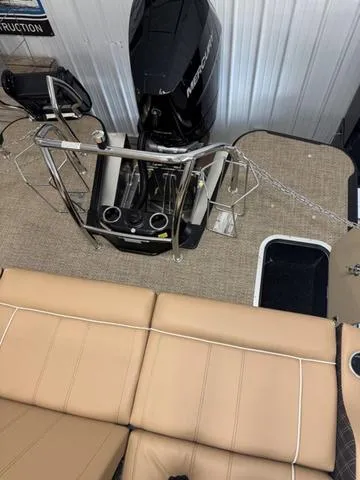 Slide: The Image of 2025 Barletta Lusso L25UC boat interior with tan seating and Mercury outboard motor. - 9