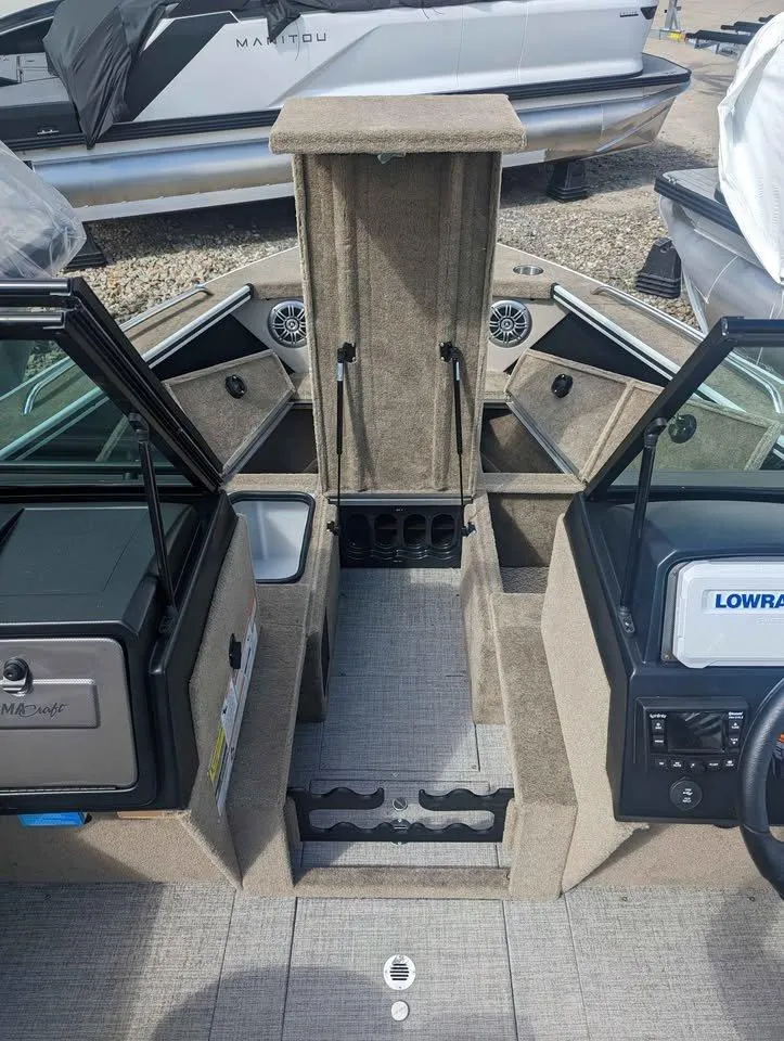 Slide: The Image of 2024 Alumacraft Trophy 185 boat interior with storage compartments and control panel. - 10