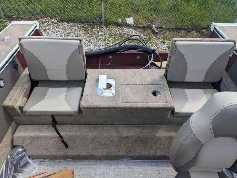 Slide: The Image of 2024 Alumacraft Trophy 185 boat interior with two cushioned seats and storage compartment. - 12