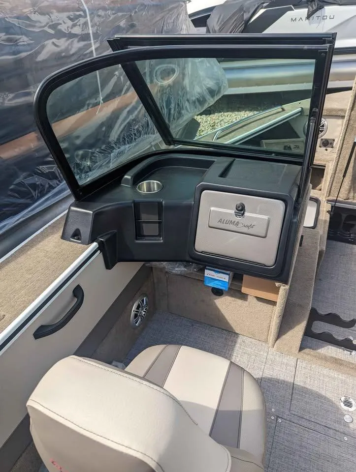 Slide: The Image of 2024 Alumacraft Trophy 185 boat interior with seating and storage compartment. - 13