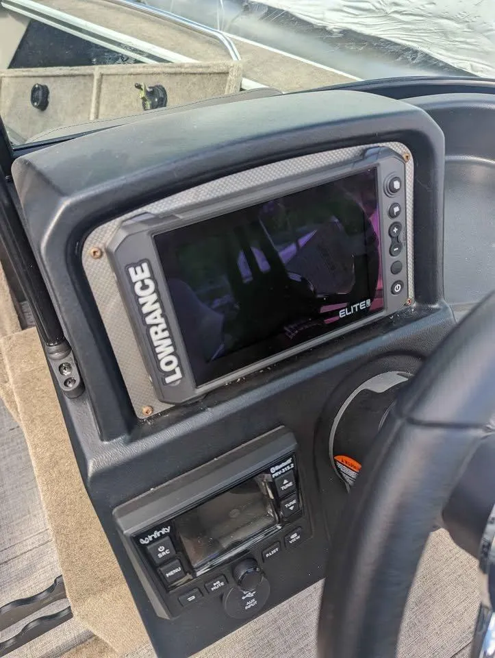 Slide: The Image of 2024 Alumacraft Trophy 185 dashboard with Lowrance Elite fishfinder and control panel. - 15