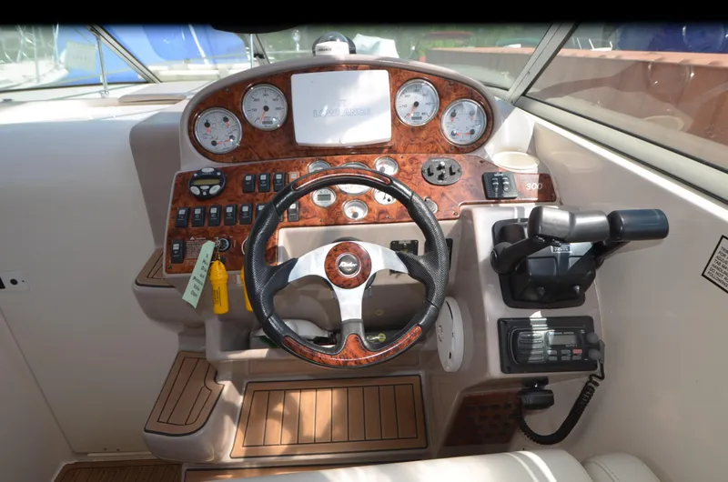 Slide: The Image of 2005 Rinker Fiesta Vee 300 EC boat dashboard with steering wheel and control panel. - 10