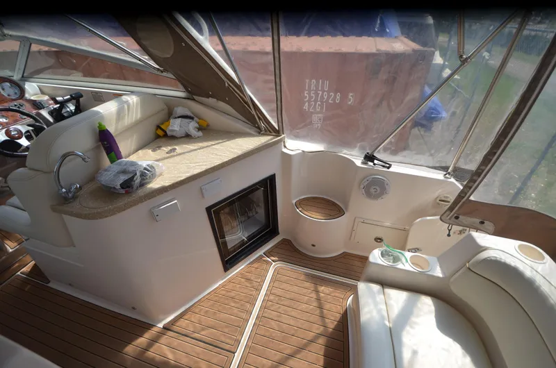 Slide: The Image of 2005 Rinker Fiesta Vee 300 EC boat interior with seating and kitchenette. - 12