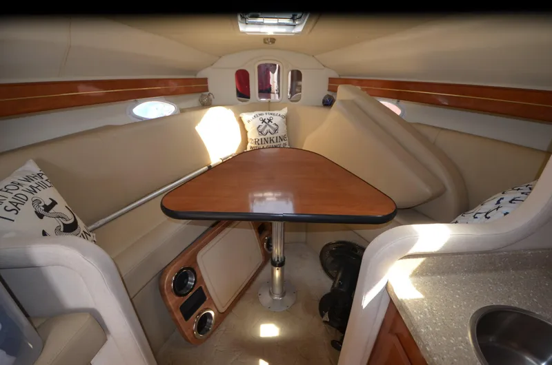 Slide: The Image of 2005 Rinker Fiesta Vee 300 EC cabin interior with seating and table. - 14