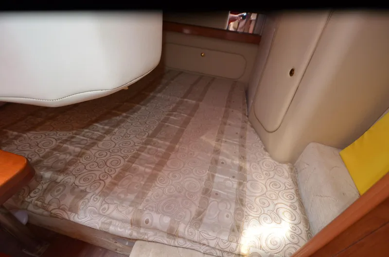 Slide: The Image of 2005 Rinker Fiesta Vee 300 EC cabin interior with patterned bedding. - 15